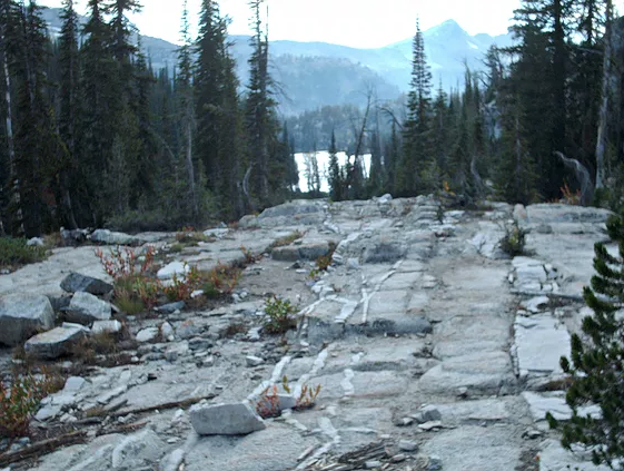 Bare granite approach to glimpse of lake