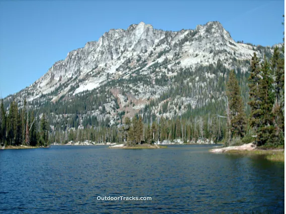 Deep blue lake, little island, trees, mt.peak