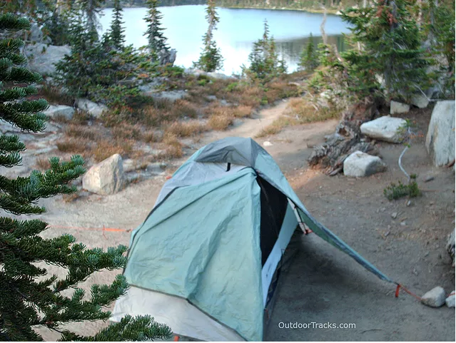 Tent in foreground, lake in background